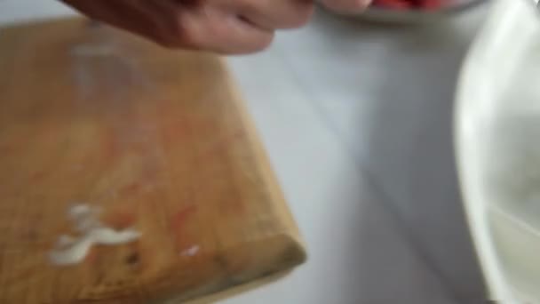 Mãos que servem rolos de sushi cobertos com queijo creme em um prato branco — Vídeo de Stock