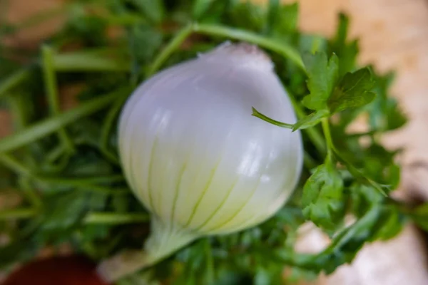 Fresh onion and coriander on a wooden table