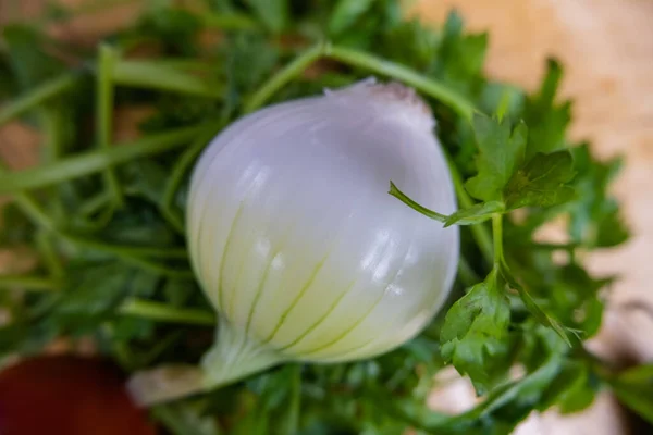 Fresh onion and coriander on a wooden table