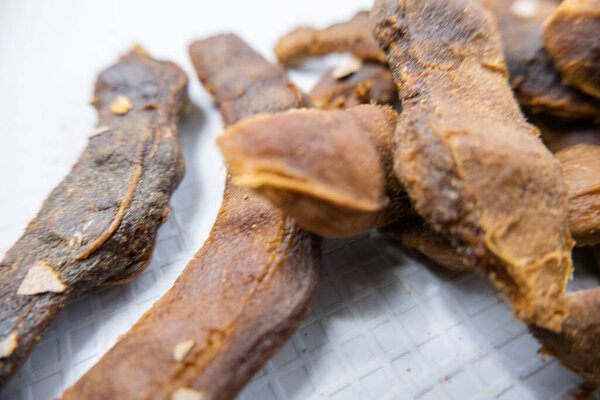 Fresh shelled tamarinds isolated on a white table