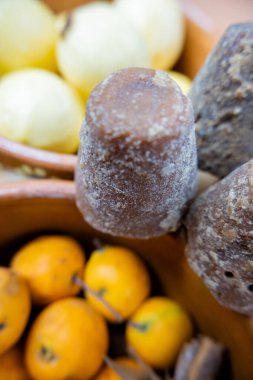 Koyu kahverengi şeker kamışları kil meyve kaselerinin üzerinde