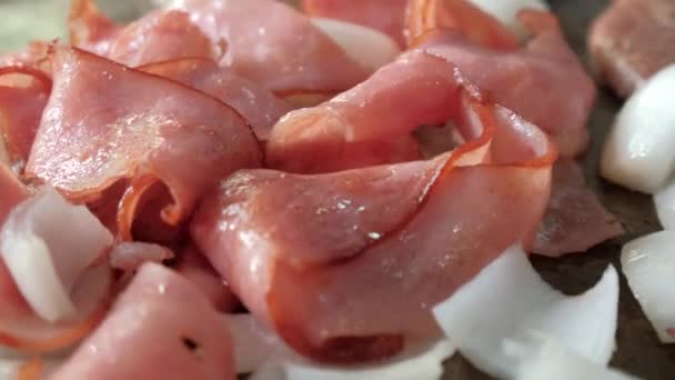 Мясо для гамбургеров со свиной ногой и ломтиками лука сверху — стоковое видео