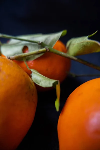 Tangerines isolated on a table with dark tablecloth — Stock Photo, Image