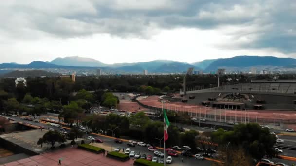 Estadio de la universidad mexicana rodeado de árboles y bajo un cielo nublado — Vídeos de Stock
