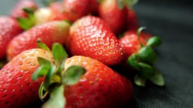 Masa örtüsü olan bir masada izole edilmiş çilekler.