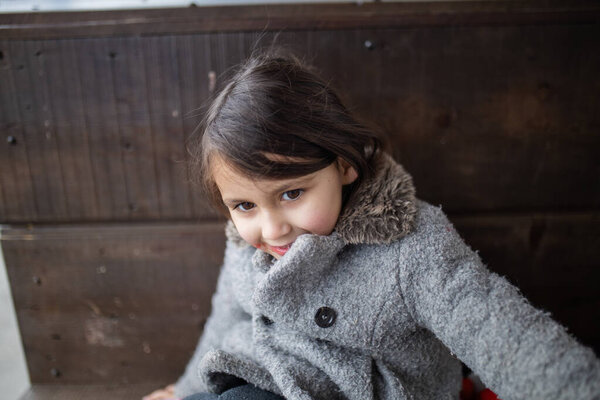 Cute little girl with strawberry syrup stain on her cheek