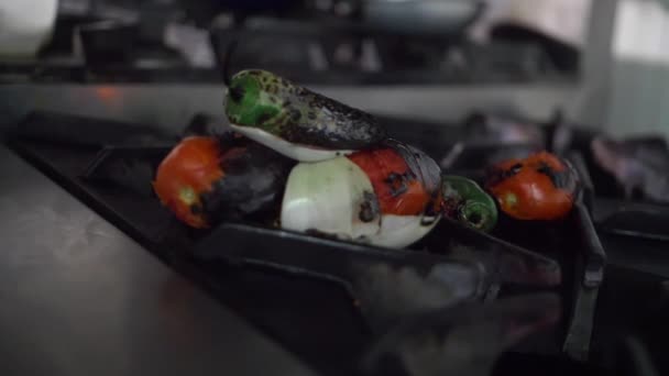 Roasted vegetables on the burner of a stove — Stock Video