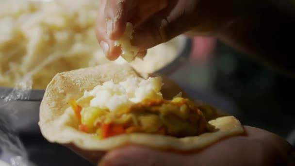 Hände fügen Kartoffelpüree zu einem Taco mit weicher Tortilla hinzu — Stockvideo