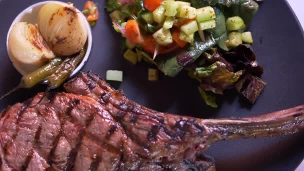 Gegrilltes Fleisch, Salat, geröstete Zwiebeln und Chilischoten auf dem Teller — Stockvideo