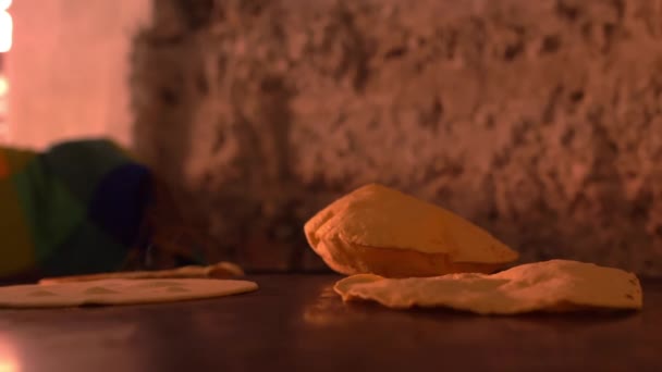 Handmade tortillas puffing up on hot black surface — Stock Video