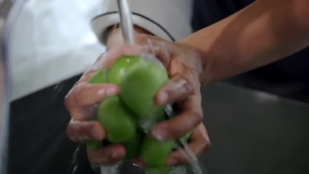 Close-up de mãos masculinas segurando e lavando tomates verdes — Vídeo de Stock