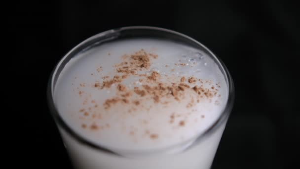 Glass of traditional Mexican horchata water with black background — Stock Video