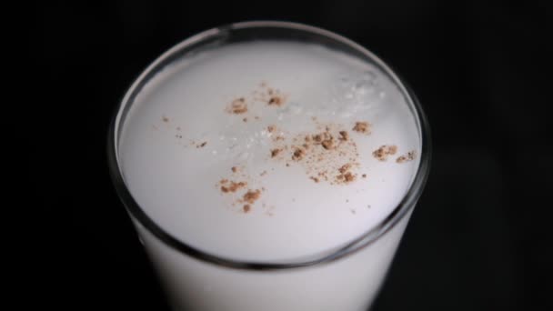 Glass of traditional Mexican horchata water with black background — Stock Video