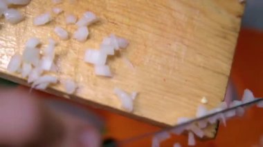 Tahta kesme tahtasından doğranmış soğan süpürmek