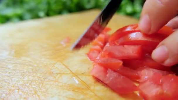 Ręce siekają pomidora na desce do krojenia — Wideo stockowe