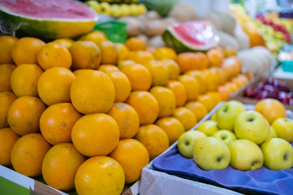 Colorful fruit stand with oranges, sliced watermelon, apples, and more — Stock Photo, Image