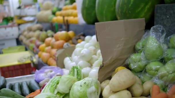 Colorful fruit and vegetables stand with onions, lettuce, watermelons, and more — Stock Video