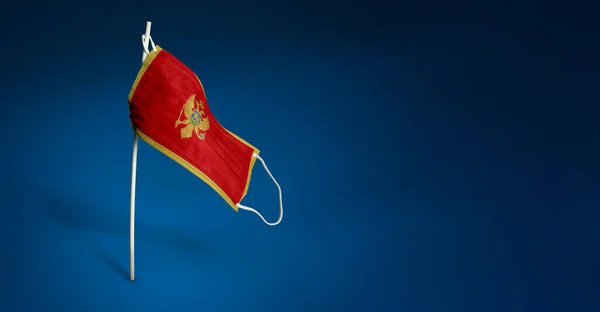 Montenegro Mask Dark Blue Background Waving Flag Montenegro Painted Medical — Stock Photo, Image