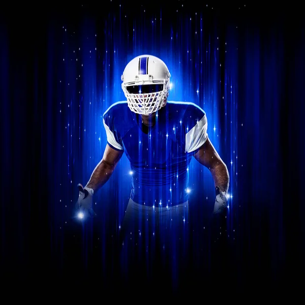 Football Player player with a superhero pose  wearing a blue uniform on a black background with blue lights.