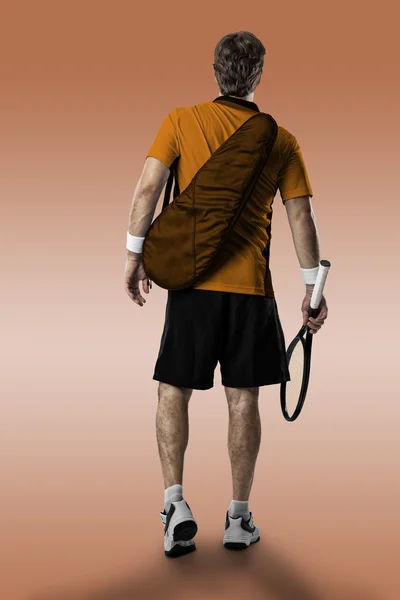 Jogador de tênis com uma camisa laranja . — Fotografia de Stock