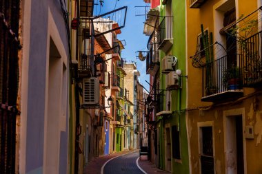 Narrow street in the historic center of the town of Villajoyosa, june 2021, Villajoyosa, Alicante, Spain. clipart
