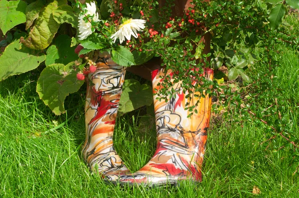 Rubber boots near the pergola — Stock Photo, Image
