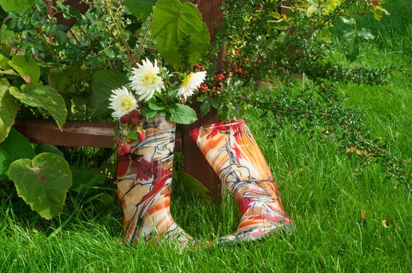 Rubber boots near the pergola — Stock Photo, Image