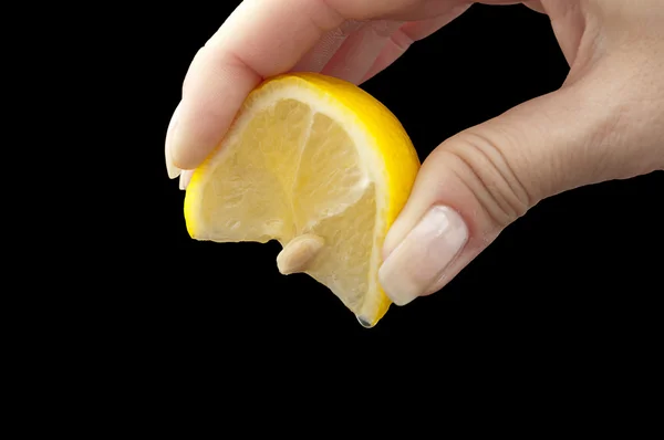 Squeeze lemon juice on hand for Royalty Free Stock Photos