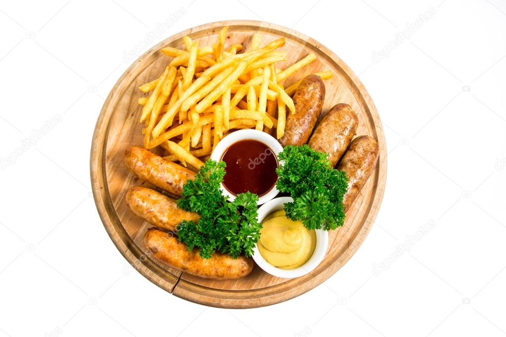 Grilled sausage with French fries and sauce on hot barbecue dish