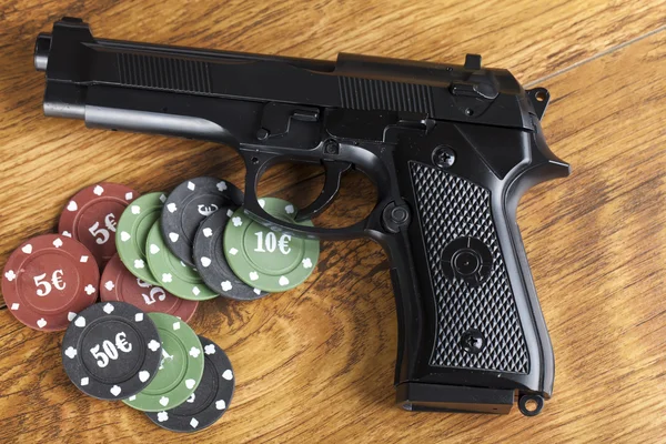 Concept de jeu illégal arme de poing avec jetons de pari — Photo