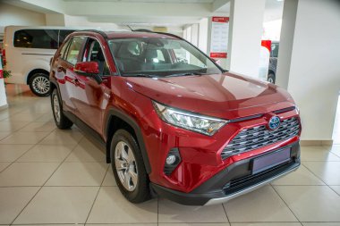 Uzhhorod, Ukraine. 20 April 2021 red car of the Japanese brand Toyota RAV 4 hybrid. SUV, crossover. Reliable and beautiful car. The car in the cabin.	