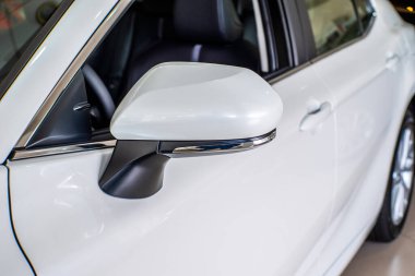 Uzhhorod, Ukraine. January 2021 white car of the Japanese brand Toyota CAMRY hybrid. Sedan, business. Reliable and beautiful car. The car in the cabin.	