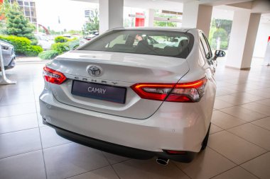 Uzhhorod, Ukraine. January 2021 white car of the Japanese brand Toyota CAMRY hybrid. Sedan, business. Reliable and beautiful car. The car in the cabin.	