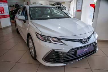 Uzhhorod, Ukraine. January 2021 white car of the Japanese brand Toyota CAMRY hybrid. Sedan, business. Reliable and beautiful car. The car in the cabin.	