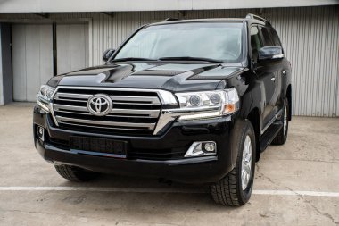 Uzhhorod, Ukraine. March 2021 black car of the Japanese brand Toyota Land Cruiser. SUV, 4x4. Reliable and beautiful car.	