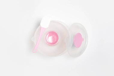 Plastic bowl with silicone spatula isolated on white background.Baking bowl with lid. High-resolution photo.