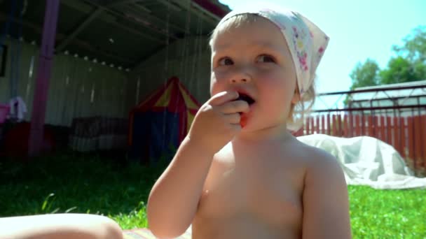 Cute little girl eats cherry — Stock Video