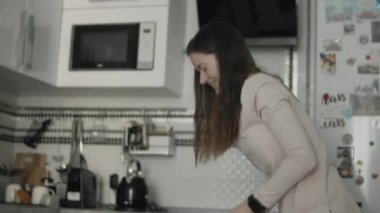 Evde köpekle oynayan genç bir kadın.