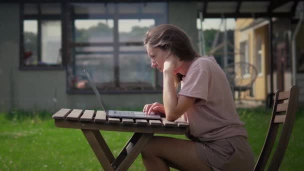 Woman Is Working With Laptop In The Garden — Stock Video