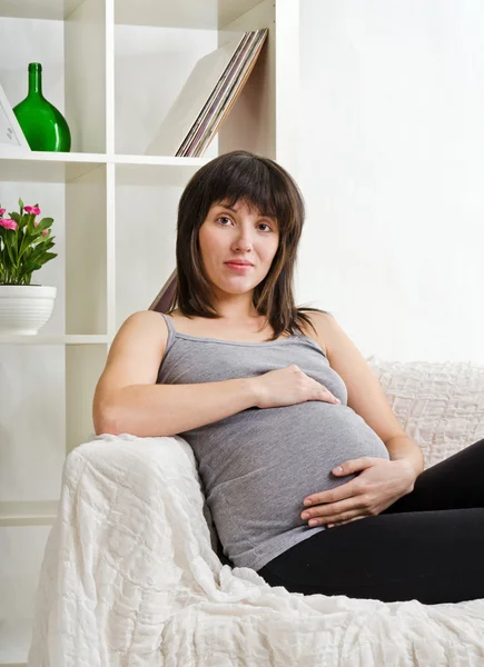 Die junge schöne schwangere Frau — Stockfoto