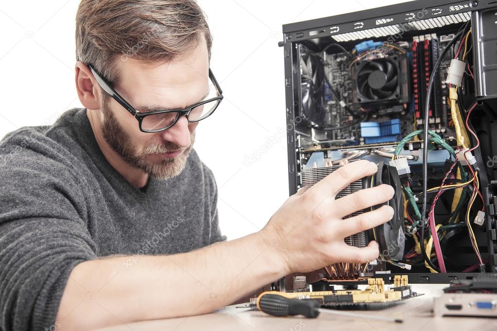 Computer technician installs cooling system.