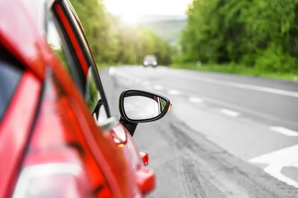 Červené auto na silnici. — Stock fotografie