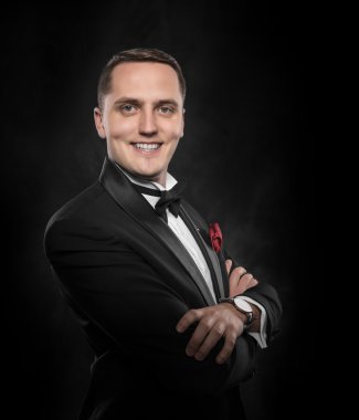 Siyah takım elbiseli genç yakışıklı adam..