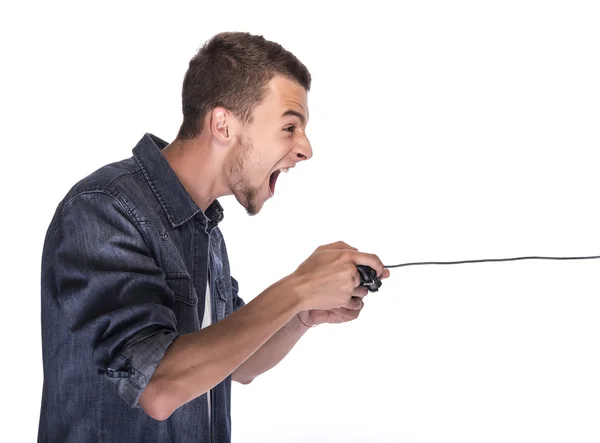 Junger Mann spielt mit Gamepad auf Konsole oder Computer. — Stockbild Junger Mann spielt auf Konsole oder Computer. — Stockfoto