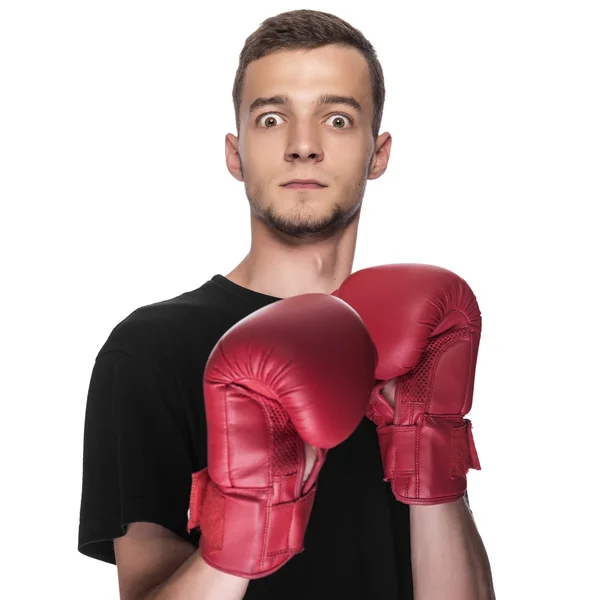 Cowardly young man in red boxing boxing gloves. — Stock Photo, Image