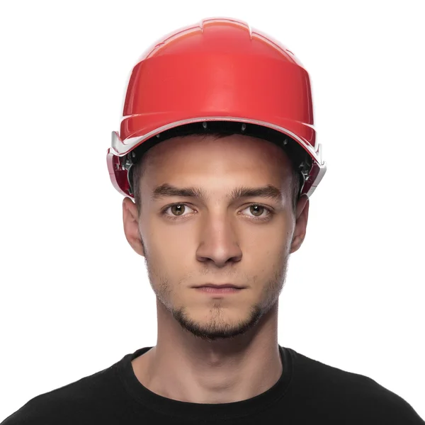 Jovem em um capacete de construção . — Fotografia de Stock