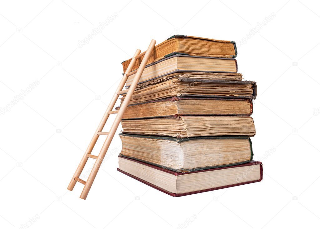 Stack of old books and wooden ladder isolated on a white background.