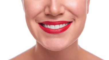 Womans face with red lipstick on the lips and white teeth.