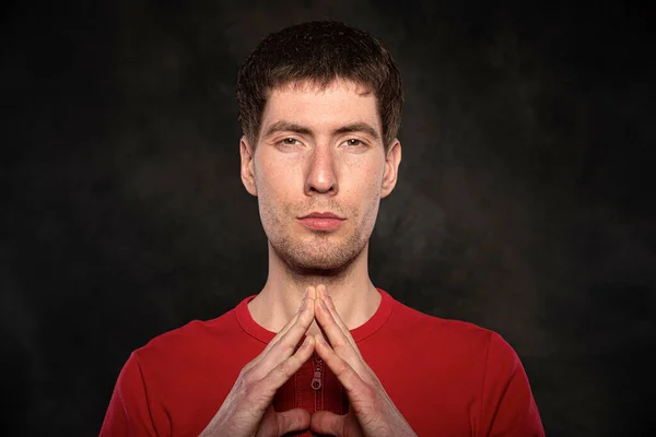 Portrait of a young man against a dark background — Stock Photo, Image