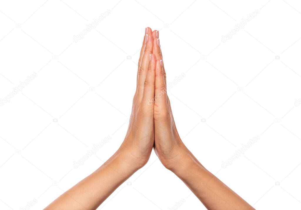 Female hands folded together isolated on a white background.